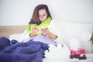 Guest with an illness using her phone