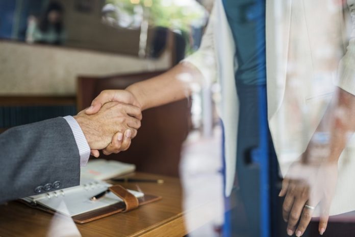 Professionals shaking hands - employee benefits