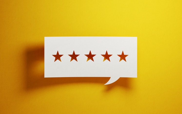 Feedback Concept - White Chat Bubble With Cut Out Star Shapes Over Yellow  Background — LODGING
