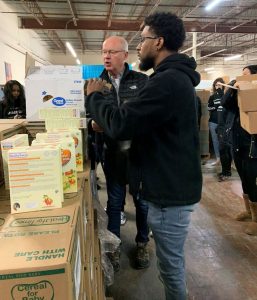 President and CEO Mark Laport assists a Concord associate with gathering and organizing supplies during Concord’s 11th annual Share Day.
