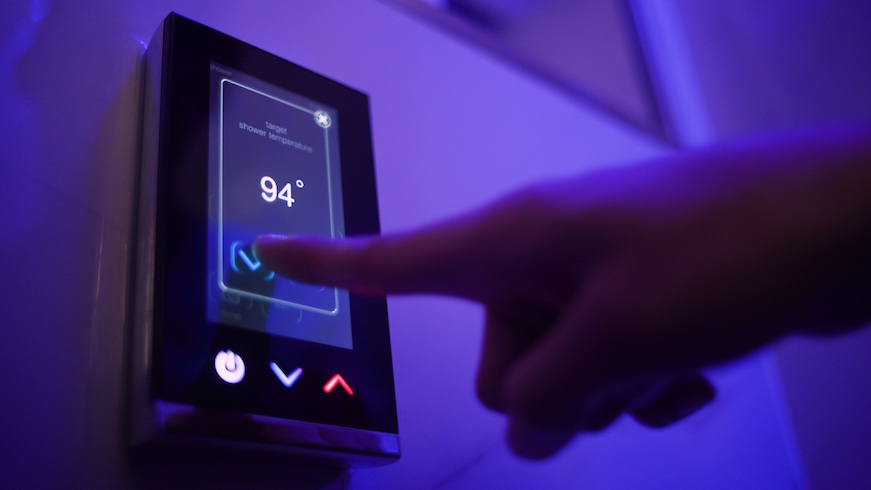 A guest uses a touchpad to set the shower temperature at The Sinclair hotel. (Credit: Sinclair Holdings LLC)