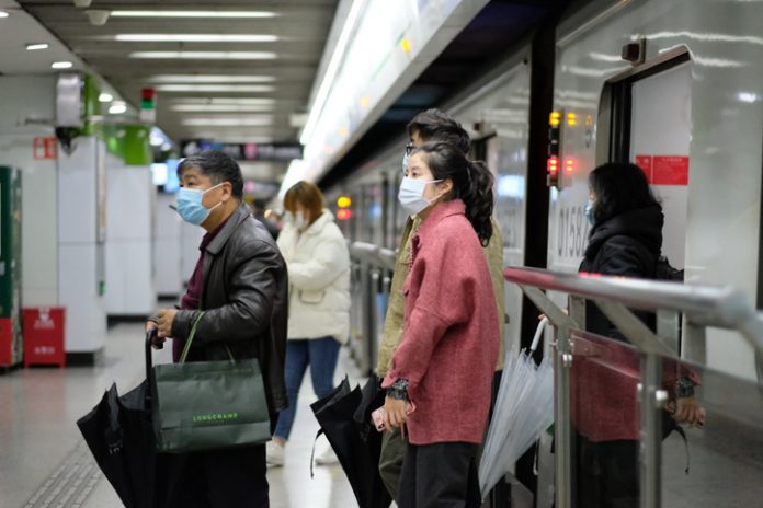 Shanghai/China-Jan.2020: New type coronavirus pneumonia in Wuhan has been spreading into many cities in China. People wearing surgical mask walking out from subway in Shanghai