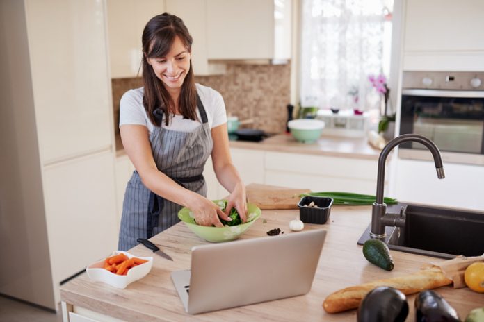 woman cooking with computer