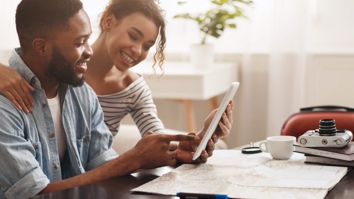 Couple planning vacation trip, searching places to visit Planning travel and booking online