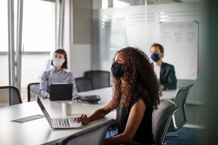 Meeting attendees wear face masks
