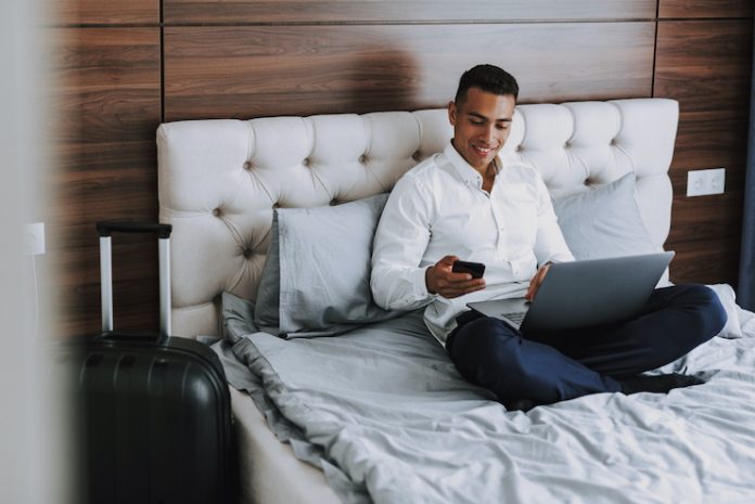 Business traveler uses multiple devices in a guestroom