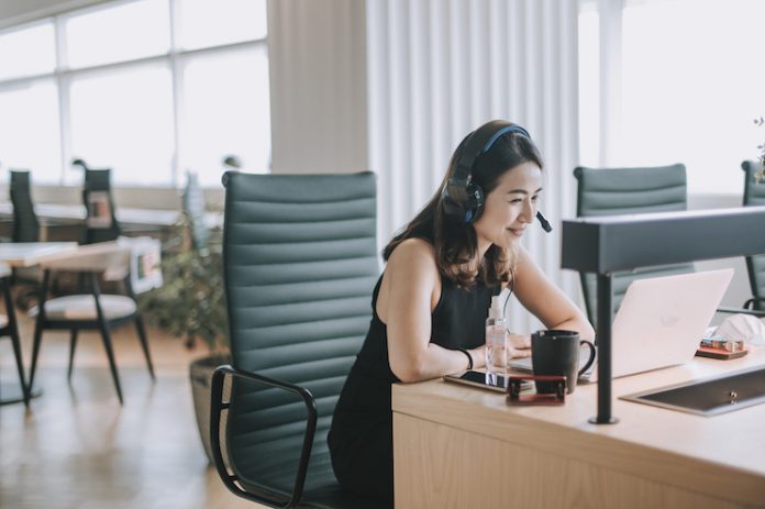 A member of a hotel sales team answers a call virtually