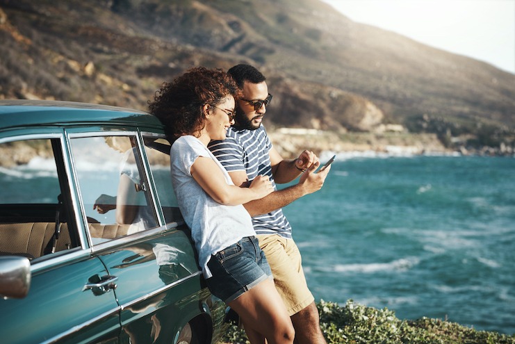 travelers on a roadtrip using their phone on vacation