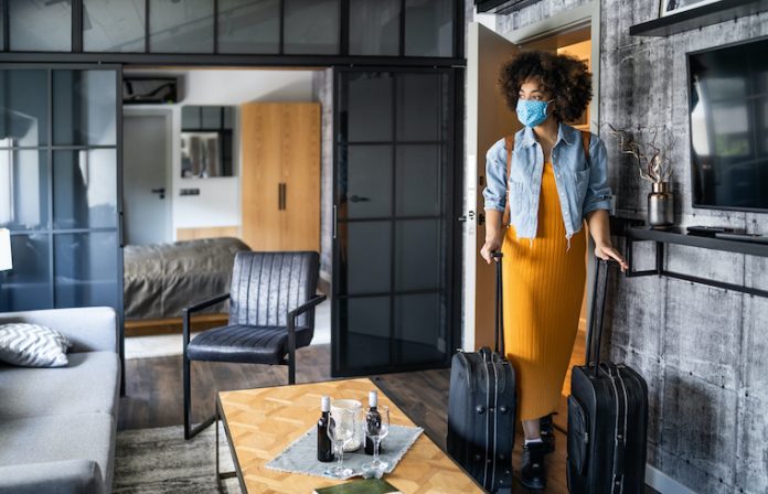 traveler in hotel wearing face mask